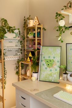 a desk with plants and pictures on it