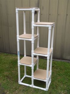 three white plastic shelves sitting in the grass