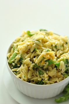 a white bowl filled with pasta and broccoli