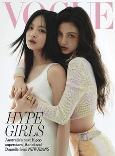 two young women hugging each other on the cover of a magazine, one is wearing a white top