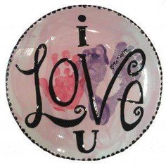 a pink plate with the words i love you painted on it