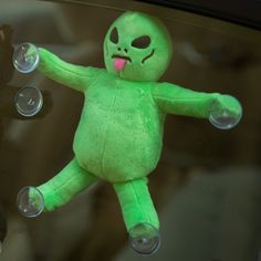 a green stuffed animal with bubbles in its mouth