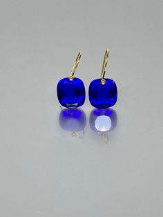 Beautiful faceted ink blue color sapphire drop earrings. The faceted rectangel drops are attached to 14K/18K  SOLID GOLD ear wires.  The earrings are elegant and have a lux look. A truly gorgeous pair of earrings. ** SOLID GOLD EAR WIRES:  The ear wire ends are stamped as proof of being 14K solid gold. In addition, extra work was done at the end of the ear wires to prevent any sort of pain or injury while inserting them through the ear lobes. **The 14K WHITE solid gold ear wires are RHODIUM plated to prevent tarnish of the ear wires over time. * Quality: Superb  AAA+ Flawless Ink Blue Sapphire * Carat (26 ct.) *  Stone Shape: Rectangle * Stone Cut : Emerald cut * The dimension of stones: 16x14 mm/ 0.6x0.5 Inches *Metal:  14K SOLID GOLD * Type of Gemstone: lab created * Earrings drop length Blue Briolette Earrings For Formal Occasions, Modern Blue Jewelry With Rectangular Stone, Blue Rectangular Faceted Jewelry, Blue Briolette Jewelry For Party, Modern Blue Rectangular Jewelry, Blue Tanzanite Drop Earrings, Blue Tanzanite Teardrop Earrings, Blue Drop Earrings With Ethical Gemstones, Modern Sapphire Earrings For Formal Occasions