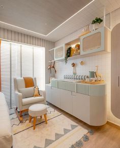 a living room filled with furniture and lots of white decor on top of a hard wood floor