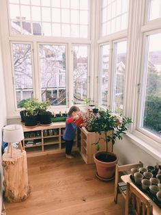 a young boy is standing in the sun room