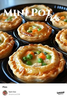 mini pot pies with peas and carrots in a black pan on top of a stove