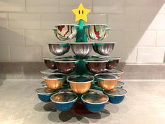 there are many bowls stacked on top of each other in the shape of a christmas tree