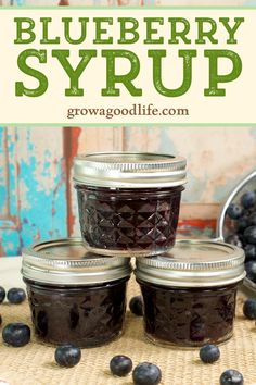 blueberry syrup in glass jars with berries around it and text overlay reading how to make blueberry syrup