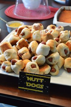 there is a plate full of hot dogs on display at the table for everyone to eat