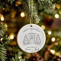 a first christmas ornament hanging from a tree