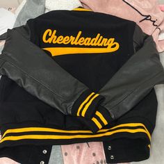 Brand New Never Worn Varsity Letterman Jacket. Black And Gold. With Cheerleading Patch On The Back #Vintage #Letterman #Cheerleading #Highschool Fall Yellow Letter Print Outerwear, Yellow Varsity Jacket For Streetwear, Yellow Varsity Outerwear For College, Yellow Long Sleeve Varsity Jacket, Yellow Varsity Jacket For College In Fall, Letterman Jacket Outfit, Varsity Letterman Jackets, Varsity Jackets, Letterman Jacket