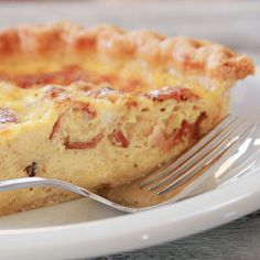 a piece of quiche on a plate with a fork