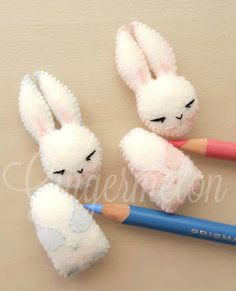 two bunny pencil holders with one holding a pencil