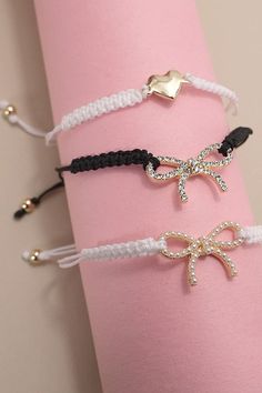 Adjustable Rope Band Pearl Heart Bow Bracelet, a delightful fusion of elegance and charm. Crafted with attention to detail, this bracelet features a unique combination of a rope band, adorned with lustrous heart pearls, rhinestone bow, pearl bow to chose from. The adjustable design ensures a perfect fit for every wrist, while the timeless pearls add a touch of sophistication. DIMENSION length: adjustableclasp: Adjustablemetal finish: Gold Platingproduct: Lead & Nickle Compliantanti-tarnish: Doub Elegant Bracelets For Valentine's Day Party, Elegant Valentine's Day Bracelets For Party, Elegant White Heart Bracelet For Party, Elegant White Heart Charm Bracelet, Elegant White Heart Bracelet For Valentine's Day, Elegant White Heart Bracelet For Wedding, Elegant White Heart Bracelet, Elegant White Heart-shaped Bracelet, Elegant Heart Bangle Bracelet For Party