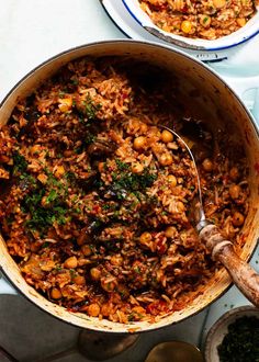 two pans filled with food sitting on top of a table