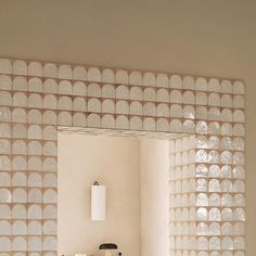 a bathroom with a sink and mirror that has white circles on the wall behind it