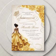 a white plate topped with a yellow and gold princess themed birthday party card on top of a table