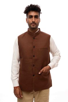 A brown woolen Nehru jacket is a fashionable and practical garment that combines the traditional Indian Nehru collar design with the warmth and comfort of woolen fabric. The Nehru jacket, inspired by Jawaharlal Nehru's signature style, features a stand-up collar that extends down the front without lapels, lending a unique and sophisticated look. Formal Brown Cotton Blazer, Brown Tweed Jacket For Winter Semi-formal, Brown Tweed Jacket For Semi-formal Winter Occasion, Brown Stand Collar Blazer For Winter, Brown Winter Blazer With Stand Collar, Traditional Stand Collar Blazer For Fall, Traditional Festive Outerwear For Work, Traditional Semi-formal Winter Outerwear, Traditional Outerwear With Stand Collar For Work