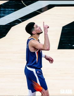 a basketball player is about to dunk the ball