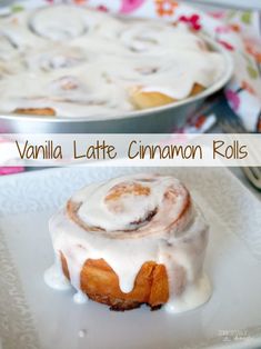 vanilla latte cinnamon rolls with icing on a plate next to a cake pan