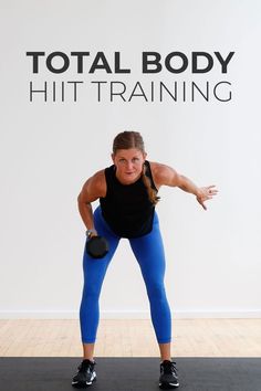 a woman in blue pants and black tank top doing squat exercises