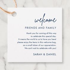 a white card with the words welcome friends and family written in blue ink on it