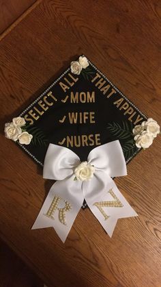 a decorated graduation cap with flowers and ribbons on it that says,'mom wife nurse '