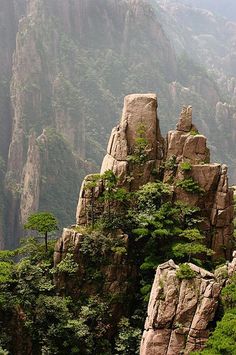 the mountains are covered in green trees and rock formations, as well as some rocks that have been carved into them