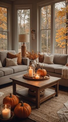 a living room filled with lots of furniture and candles on top of a coffee table