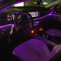 the interior of a car with purple lights