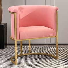 a pink chair sitting on top of a rug