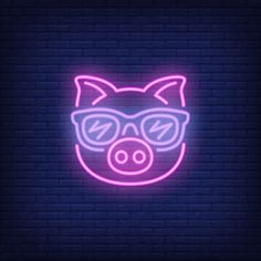 a neon pig with glasses on it's face in front of a brick wall