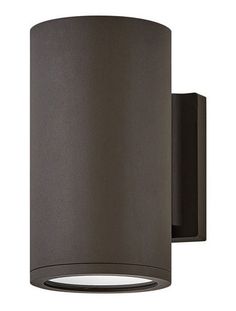 an outdoor wall light that is on the side of a white wall and has a black cylinder