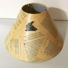 a paper cone shaped vase sitting on top of a table