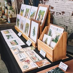 there are many pictures on display at the table with cards and other items in front of them