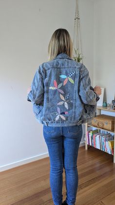 This one-of-a-kind denim jacket is a true statement piece, combining the timeless appeal of denim with playful floral designs. The back features beautiful patchwork flowers that add a burst of personality and charm, while the front is decorated with delicate hand-embroidered flowers. Size: 10 in Australian sizes. Fabric: Soft, durable denim. Style: Wear it with jeans for a cool double-denim look, or throw it over a dress for a chic, casual vibe. Whether you're heading to a casual brunch, a day o Trendy Denim Jacket With Floral Print, Blue Denim Jacket With Floral Print, Blue Floral Denim Outerwear, Trendy Floral Print Denim Jacket, Spring Denim Jacket With Patches In Dark Wash, Spring Recycled Denim Patchwork Outerwear, Denim Blue Jacket With Floral Embroidery For Fall, Spring Patchwork Recycled Denim Outerwear, Spring Patchwork Outerwear In Recycled Denim