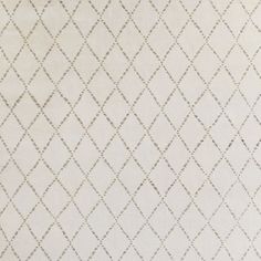 a white rug with diamond shapes on it