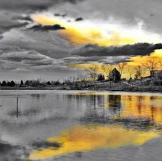 a black and white photo with yellow clouds