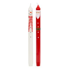 a red and white pen with a santa clause on the side, sitting next to it