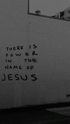 there is power in the name of jesus written on a wall next to a fire hydrant