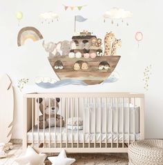 a baby's room with a crib and wall decals