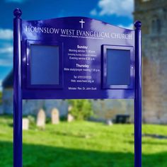 a blue sign in front of a church