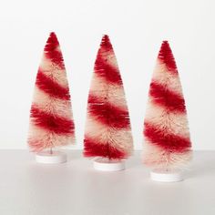 three small red and white christmas trees