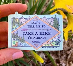 someone holding up a sticker that says, don't tell me to take a hike i'm already going