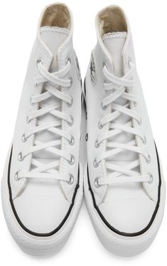 High-top buffed leather sneakers in white. · Lace-up closure · Eyelet vents and leather logo patch at inner side · Canvas lining · Foam rubber platform midsole featuring black stripe · Tonal treaded rubber outsole · Approx. 2 platform Supplier color: White/Black Converse For Women, White Chuck Taylors, White Chucks, Chuck Taylor All Star Lift, Converse White, Leather Logo, Chuck Taylor Sneakers, Chuck Taylor All Star, Chuck Taylor