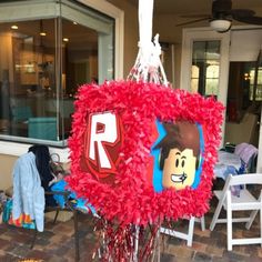 a red wreath with legos on it in front of a store