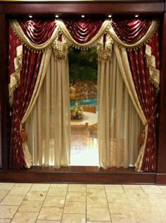 an open window with curtains and draperies in front of a tiled flooring area