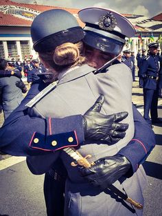 two police officers hugging each other on the street