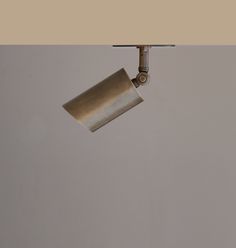 a metal lamp hanging from the side of a wall