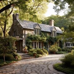 a large stone house surrounded by trees and bushes